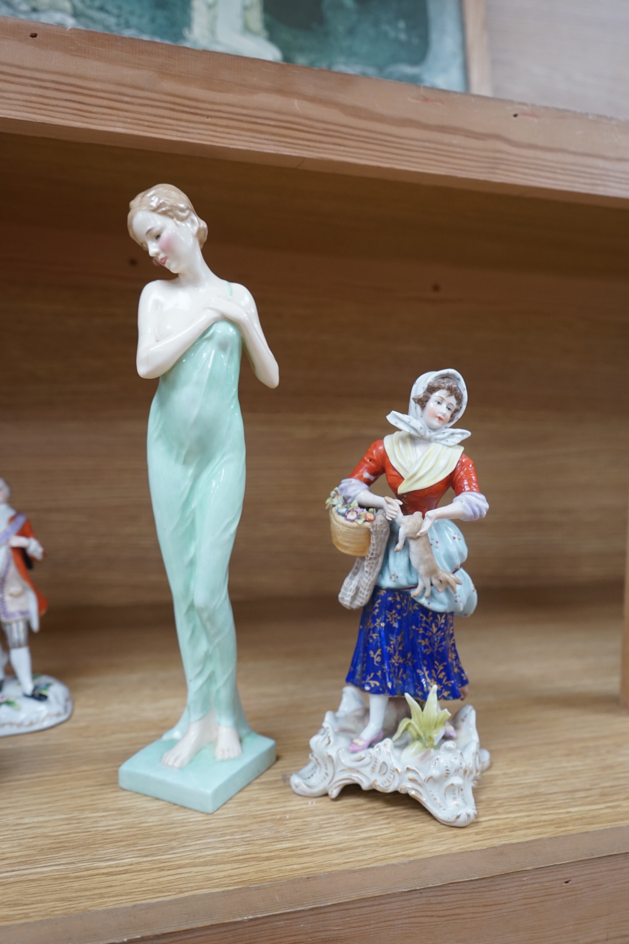 Eight Royal Doulton and 19th century German figures, including two Sitzendorf frog musicians, a Royal Doulton Celia (HN1727) and the toy seller. Condition - fair to good, substantial cracks and damage to the Celia figure